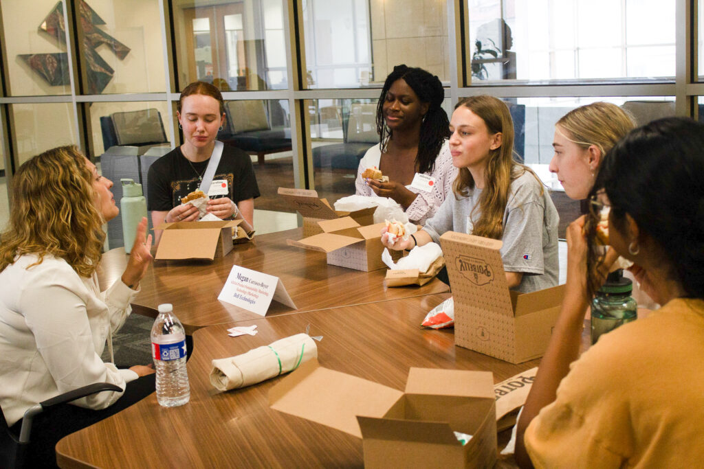 STEM Role Model eating lunch with high school summer camp participants